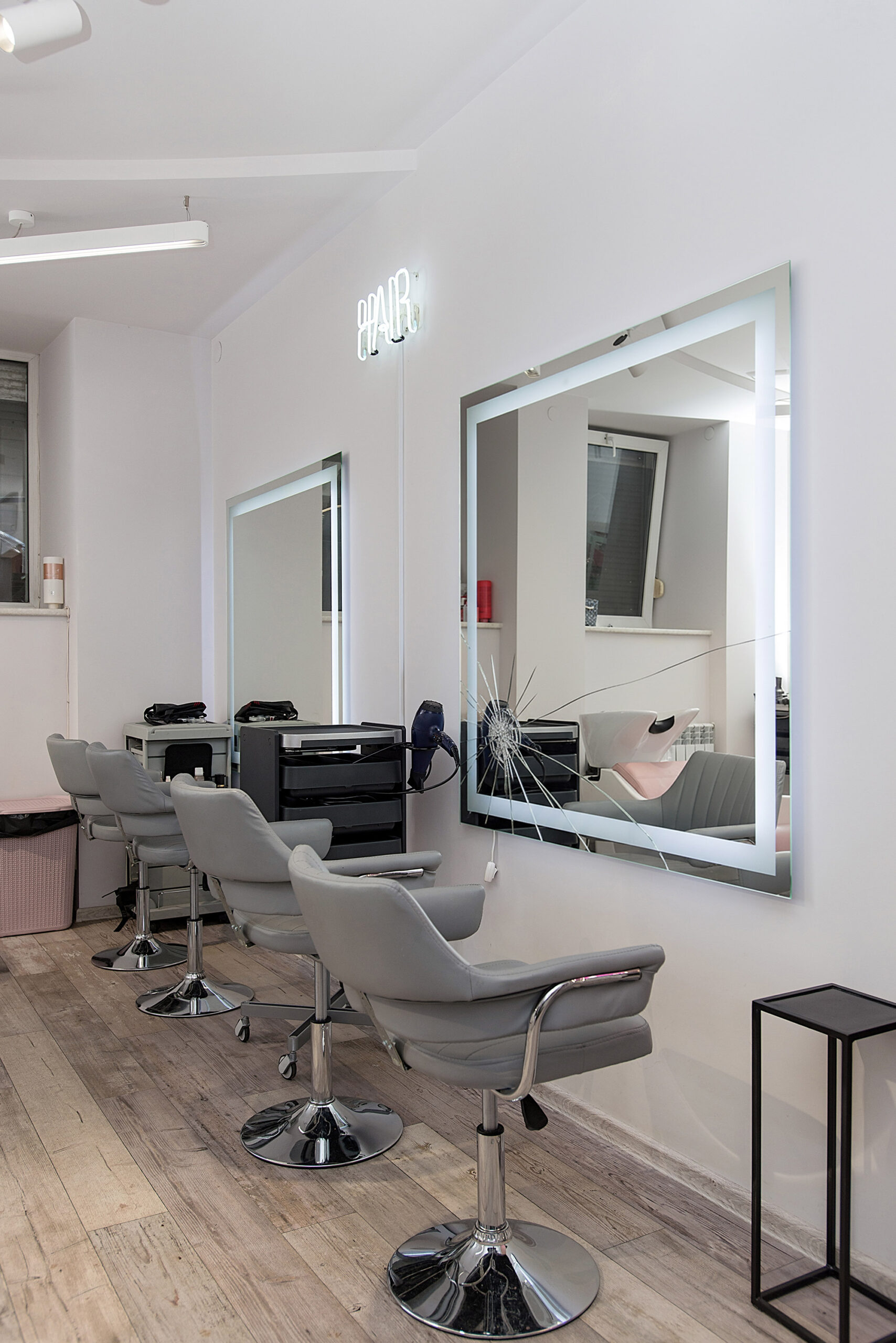 Workplace for haircut in barbershop, with backlit mirror